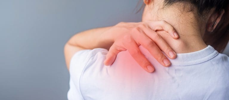 woman with her shoulder sprain, muscle painful during overwork
